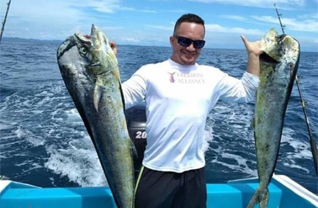 Man holding two fish in Jaco