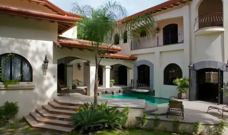 Exterior of the 6-bedroom Royale Auburn luxury villa, featuring private tropical gardens and pool in Jaco, Costa Rica.