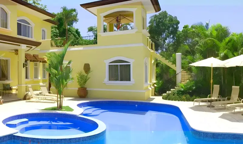 Tropical exterior and private pool of the Royale Dreams 8-bedroom luxury vacation rental in Jaco, Costa Rica.