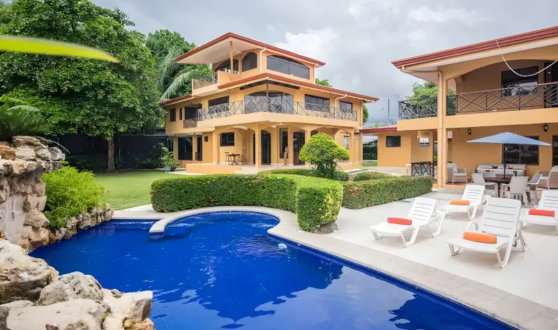 Luxury 8-bedroom Royale Gaia villa in Jaco featuring a private outdoor swimming pool and tropical lounge area.
