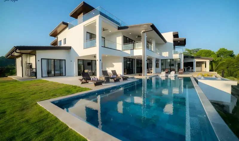 Luxury 6-bedroom Royale Hook villa in Playa Hermosa featuring a private infinity pool and modern outdoor lounge area with ocean views.